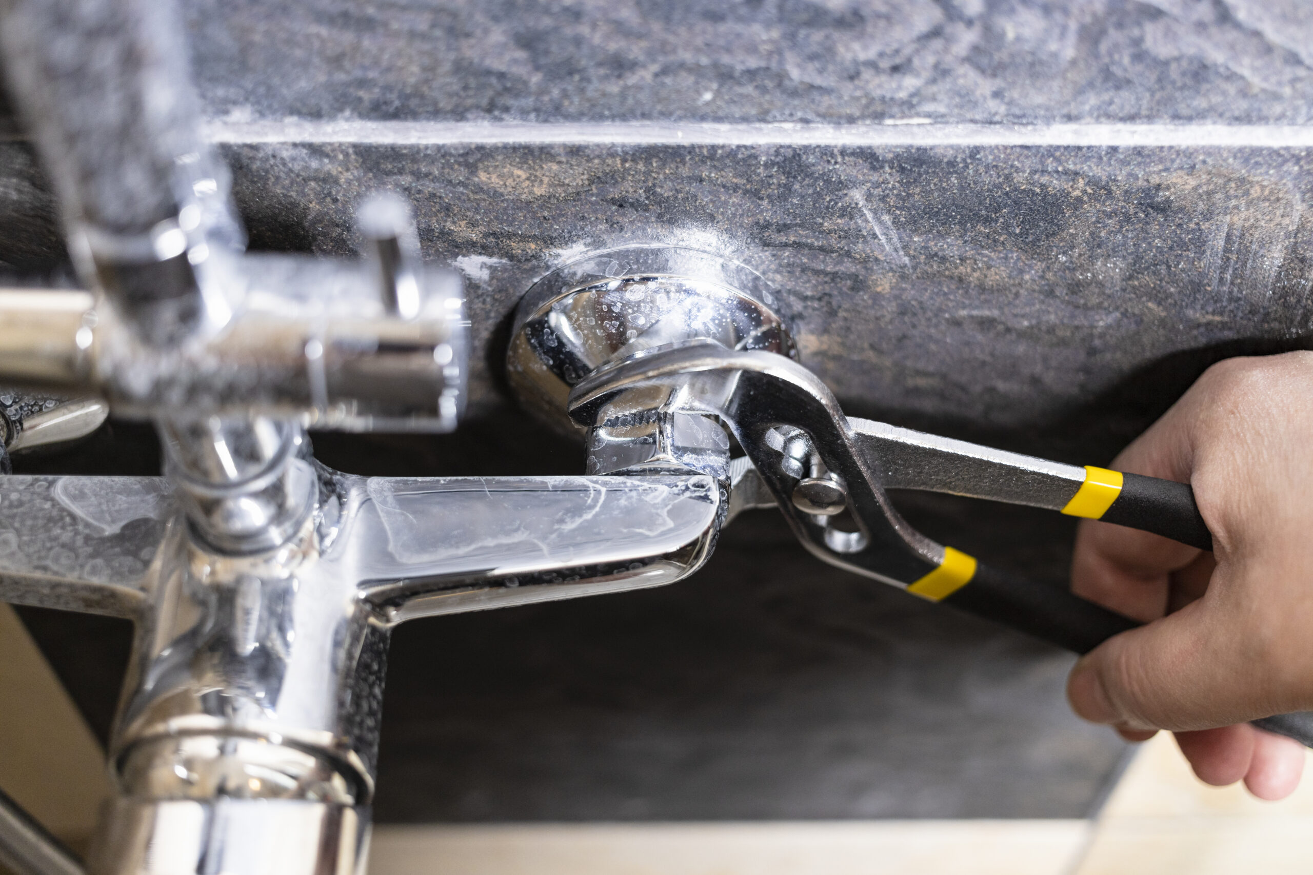 plumber unscrews nut of shower faucet close up 2023 11 27 05 20 51 utc scaled